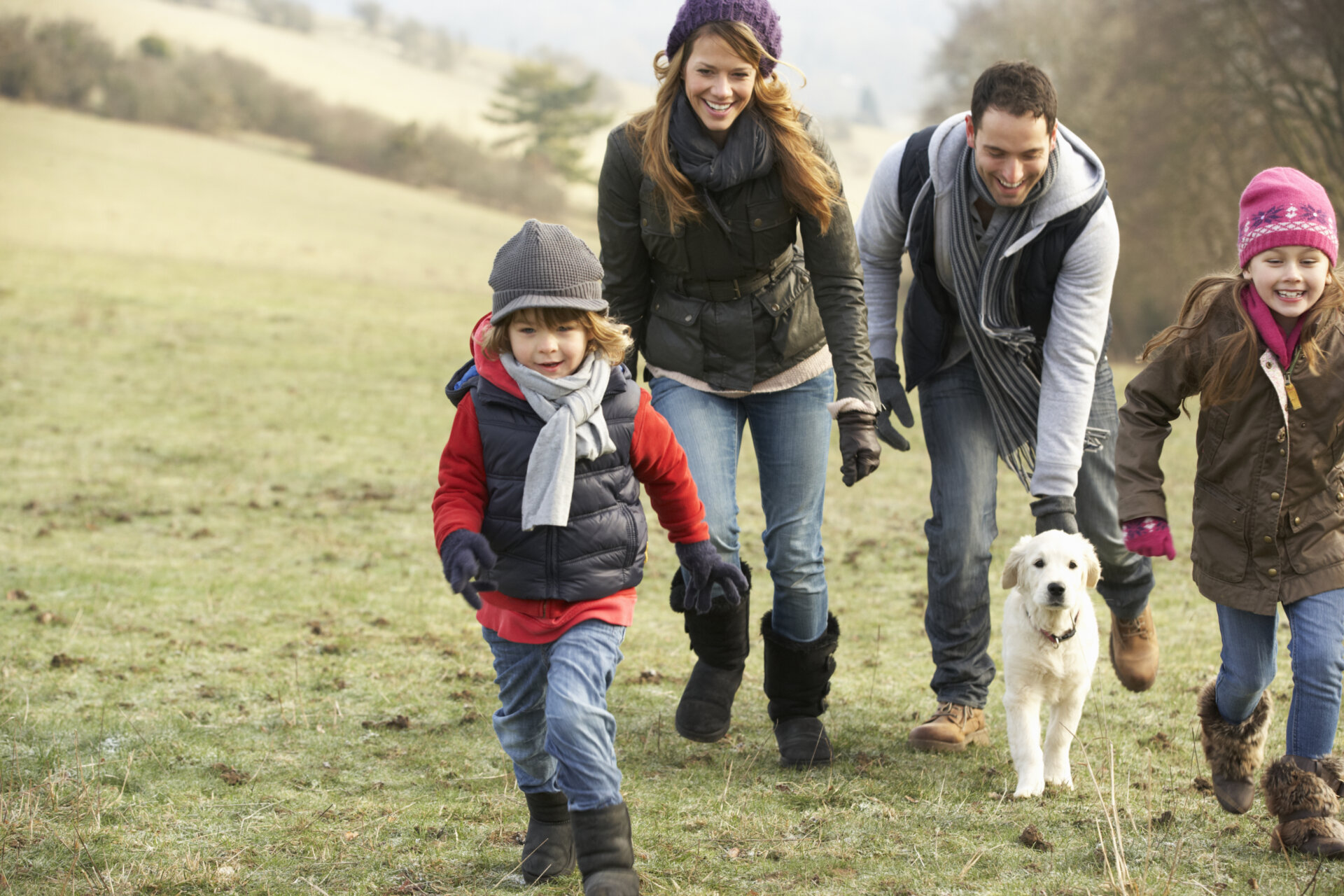 Family and dog having fun in the country during winter